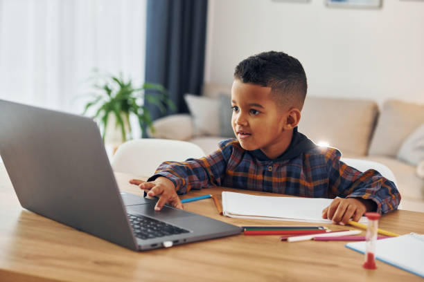 istock Cheerful young boy is at home alone 1370711304