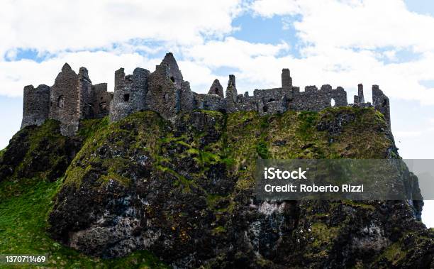Ruin Of The Old Dunluce Castle In Northern Ireland United Kingdom Nearby Bushmills Remains Of A Medieval Castel Or Historical Fortress Built With Stones On Top Of A Cliff In County Antrim Ireland Stock Photo - Download Image Now