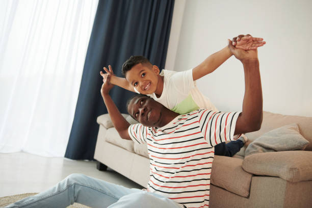 istock Active weekend time spending. African american father with his young son at home 1370711524