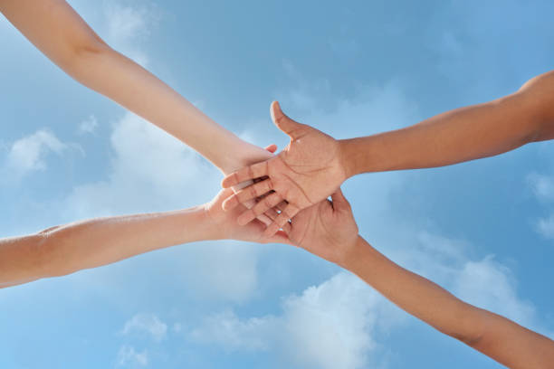 istock Shot of a group of unrecognizable people stacking their hands 1370712102