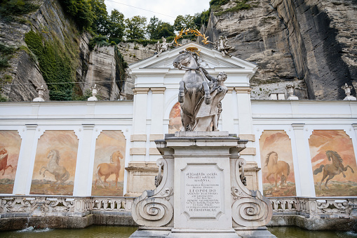Salzburg, Austria, 28 August 2021: Karajan Square and Horse Pond, place to wash parade horses of prince archbishops, baroque statue of Horse Tamer and unique frescoes on back wall, summer day