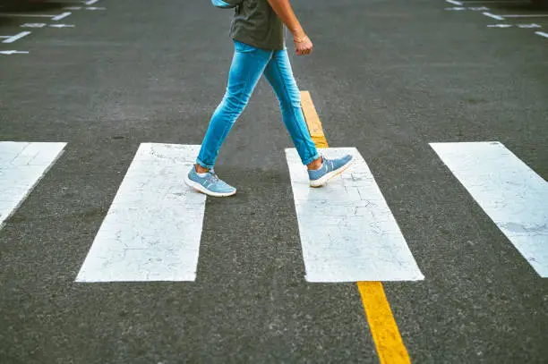 Photo of Cropped shot of an unrecognisable man walking through the city in the morning