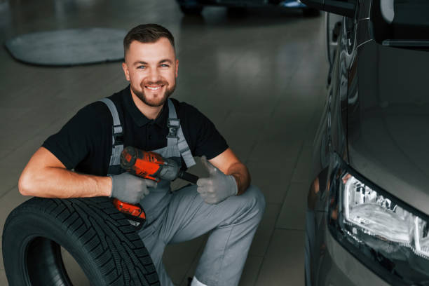 istock Using equipment. Man in uniform is working in the autosalon at daytime 1370713716