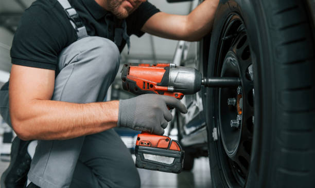 istock Modern vehicle. Man in uniform is working in the autosalon at daytime 1370713744