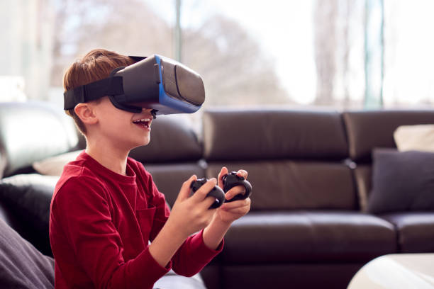 istock Son Beating Father At Computer Game As They Sit At Home Wearing Pyjamas 1370713888