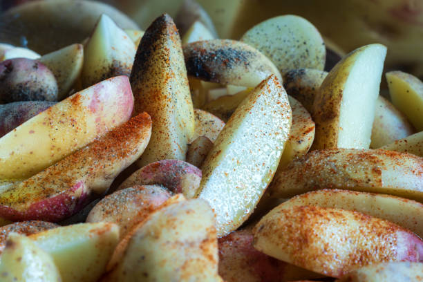 istock ripe raw cut potatoes wedges spiced background closeup 1370714545