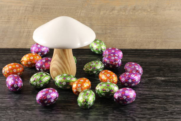 a wooden  amushroom with easter  eggs stock photo