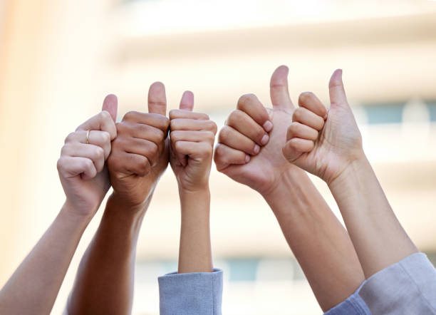 Shot of a group of business people giving the thumbs up Your fullest potential is within reach professional thank you stock pictures, royalty-free photos & images