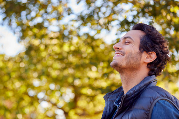 Calm Man Outdoors Relaxing And Breathing In Deeply In Autumn Park stock photo