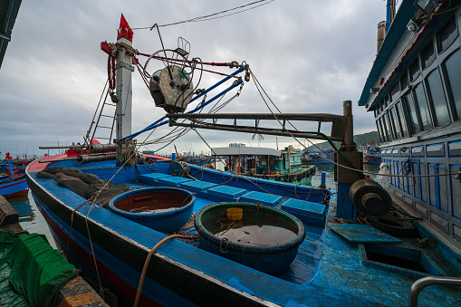 Basket boats with full of water after a heavy rain on the fishing boat at Hon Ro dock. Nha Trang city, Khanh Hoa province