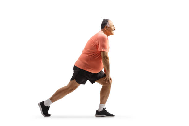 Full length profile shot of a mature man stretching his leg after exercise Full length profile shot of a mature man stretching his leg after exercise isolated on white background stretched leg stock pictures, royalty-free photos & images