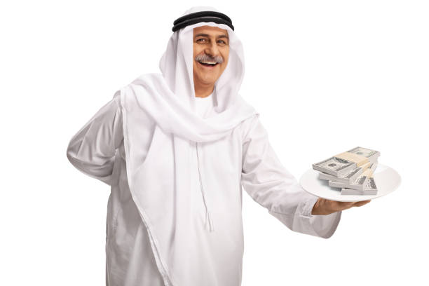 istock Mature arab man holding a plate with money 1370720158