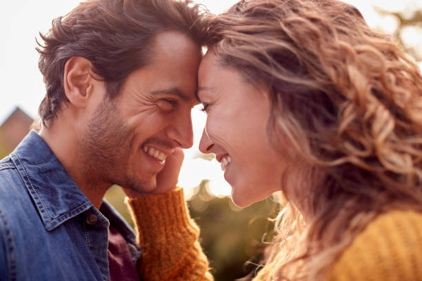 Portrait Of Happy Loving Couple Head To Head Outdoors Portrait Of Happy Loving Couple Head To Head Outdoors heterosexual couple stock pictures, royalty-free photos & images