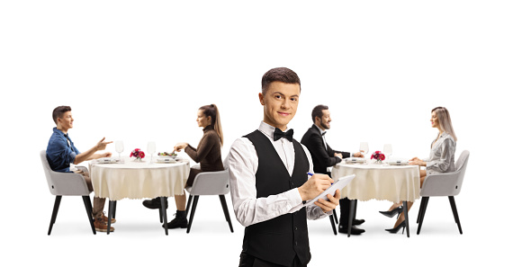 Young waiter in a restaurant and people dining in the back isolated on white background