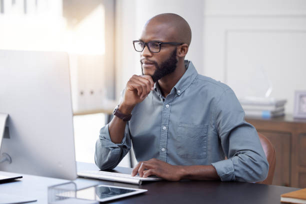 istock Shot of a young businessman using a computer in an office at work 1370723777