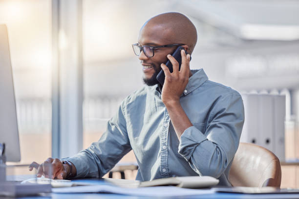 istock Shot of a young businessman using a computer while on a call at work 1370723789