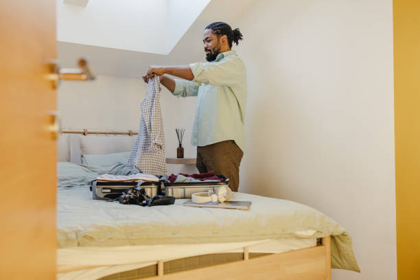 istock Packing belongings in a suitcase and preparing for a trip 1370723890