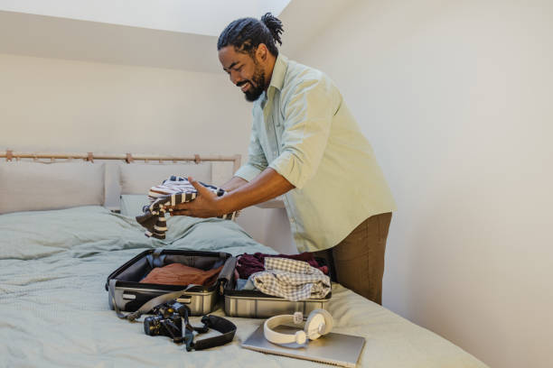 istock Packing belongings in a suitcase and preparing for a trip 1370724025
