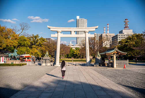24 march 2019, Hiroshima - Japan: tourist in front of Gokoku Shrine. Was founded in 1868, 1st year of the Meiji period, in Futabanosato, moved and rebuilt in the confines of Hiroshima castle in 1965