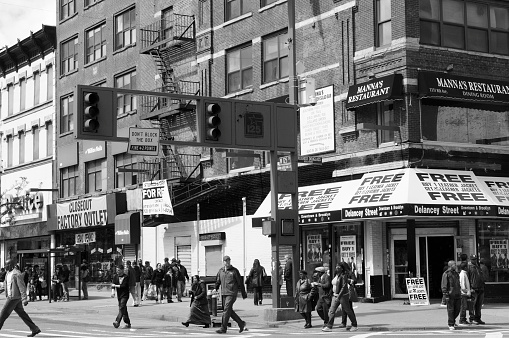 Harlem, Manhattan, NYC, USA - April/18/2010: people  at cross between 125th and Frederick Douglas Boulevard, Harlem, Manhattan, NYC, USA.