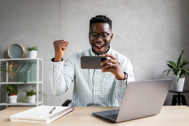 istock Young African American businessman using a smart phone in his office 1370725094