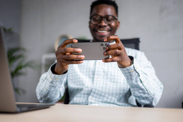 istock Young African American businessman using a smart phone in his office 1370725095