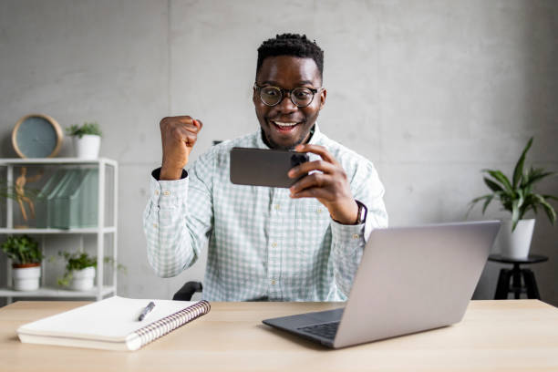 istock Young African American businessman using a smart phone in his office 1370725250