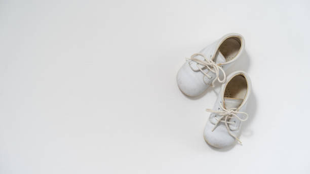 istock Baby shoes on white background 1370726993