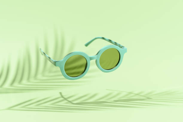 istock Levitating retro sunglasses over pastel green background, with shadows palm leaves. Creative summer minimal scene. Vacation, holidays, and party concept. 1370728174