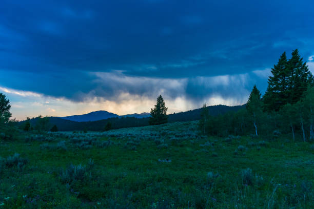 Dark clouds and a rain squall sweep across Idaho’s Caribou-Targhee National Forest