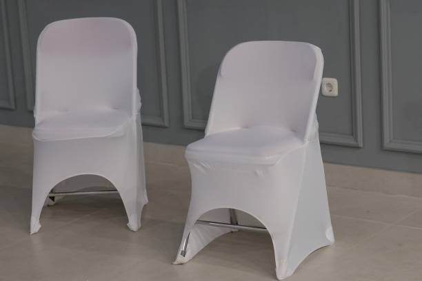 istock Two chairs covered in white cloth jackets 1370729950