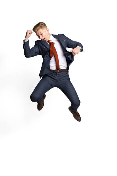 istock Excited young businessman, student, diplomat jumping isolated on white studio background. Human emotions, facial expression concept. 1370730044