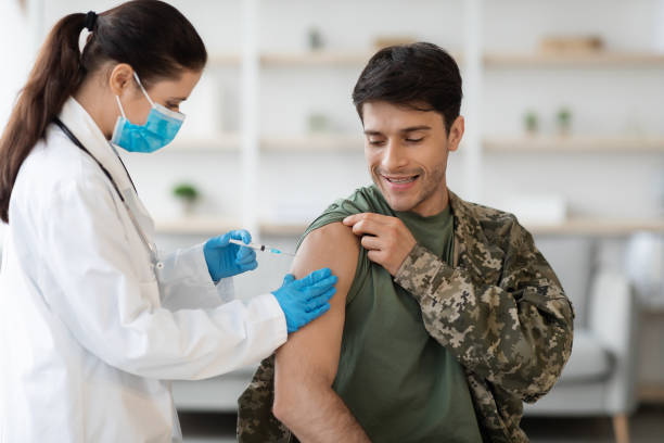 istock Cheerful soldier getting immunization against coronavirus at clinic 1370730982