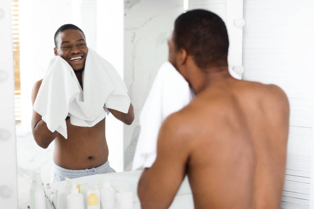 istock Morning Routine. Happy Shirtless Black Young Guy Wiping Face With Towel 1370731251