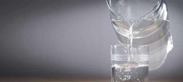 istock Pouring water into glass. Healthy drink 1370732410