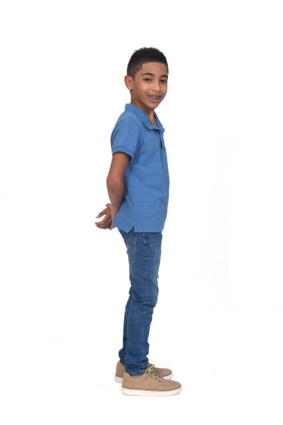 side view of boy arms on back and looking at camera on white background