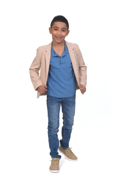 Portrait of stylish kid, boy in shirt, cap, suspenders and plaid pants smiling, posing, winking isolated over white background. Concept of childhood, friendship, fun, lifestyle, fashion. Retro style