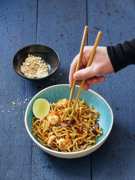 istock Man eating Thai fried noodle with seafood 1370732717