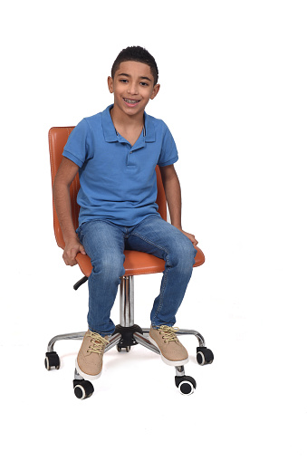 front  view of a boy sitting on a chair on white background