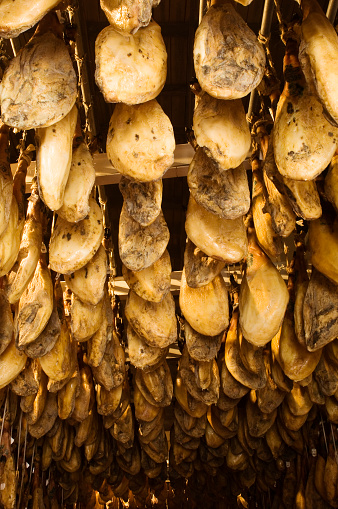 Iberian cured hams stored in a drying room during the curing process.