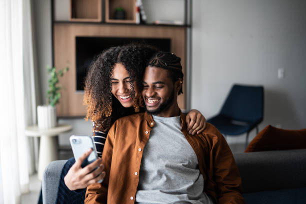istock Young couple using the mobile phone at home 1370733004