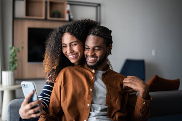 istock Young couple using the mobile phone at home 1370733007