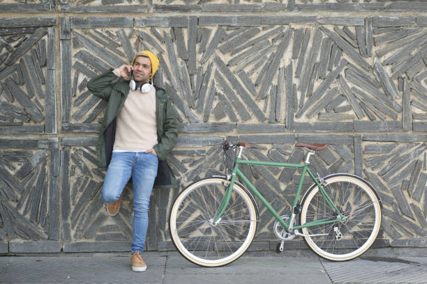 istock Hispanic man talking on phone against wall 1370733231