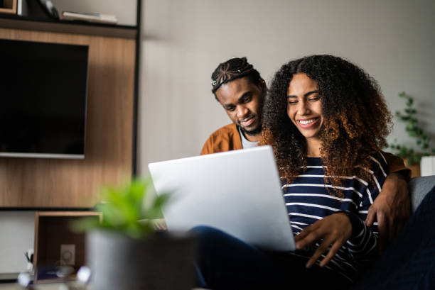 istock Young couple using the laptop at home 1370733800