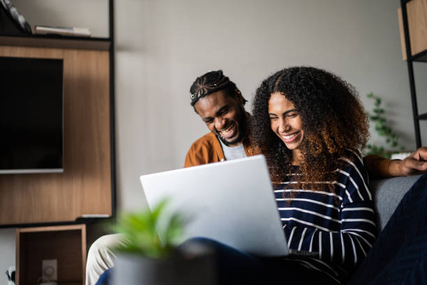 Young couple using the laptop at home