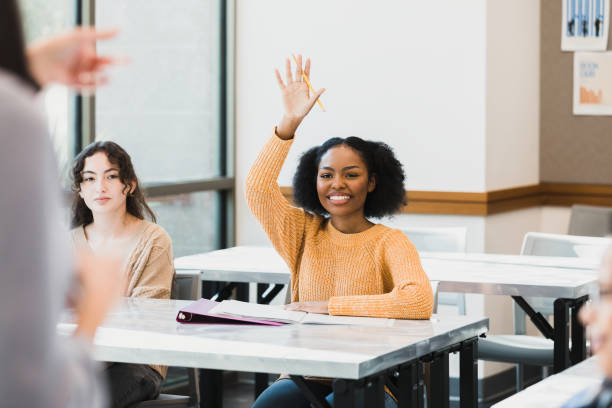 istock Unrecognizable teacher points to student with hand raised 1370735945
