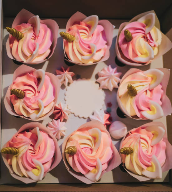 istock Delivery box with sweet unicorn cupcakes dessert 1370737195