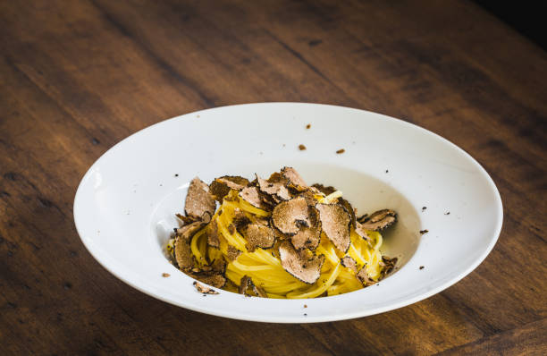istock Pasta with truffle plate on wooden table. 1370737300