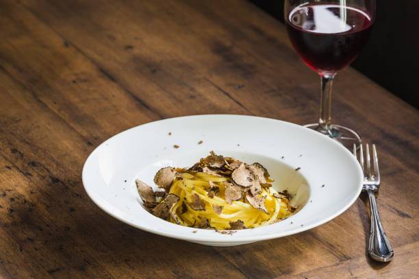 istock Pasta with truffles.Tagliatelle with fresh truffle on wooden table copy space. 1370737347
