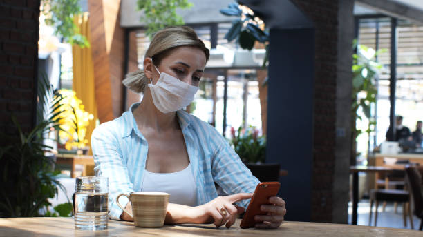 istock Woman typing message writing on smart phone in a modern cafe. 1370738925